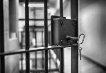 Mississippi Jail Horror: Inmates Used as Enforcers Jail cell door with key in lock.
