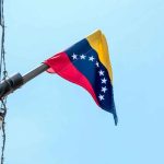 Venezuelan flag flying on a pole