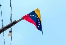 Trump’s Bold Venezuela Strikes Spark Outrage Venezuelan flag flying on a pole