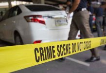 Shooter Walks Free—Alabama Outrage Erupts Crime scene tape blocking off white sedan