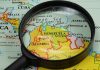 Magnifying glass focusing on Venezuela and Colombia on map