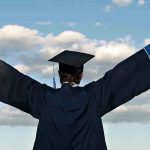 Collegiate MELTDOWN: 60% Get As—What a Crock!! Graduate in cap and gown celebrates under cloudy sky