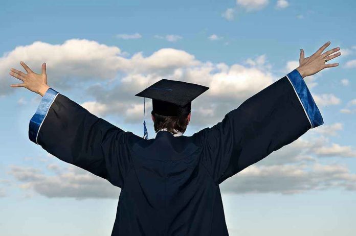 55937464 Graduate in cap and gown celebrates under cloudy sky