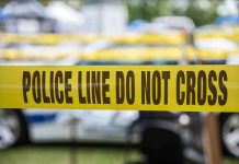 Homeowner CHARGED After Killing Teenage Burglar Yellow police line tape with Do Not Cross.