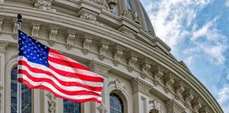 US flag in front of Capitol building