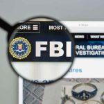 FBI website shown through magnifying glass.