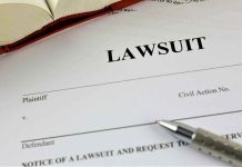 Lawsuit document with a pen and book