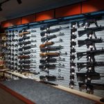 Gun Rights SHOCKER: Marijuana Users Targeted! Wall-mounted guns displayed in a store.