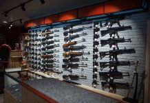 Gun Rights SHOCKER: Marijuana Users Targeted! Wall-mounted guns displayed in a store.