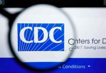 CDC Panel QUIETLY Kills Newborn Vaccine Rule CDC logo magnified on a screen.