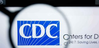 CDC Panel QUIETLY Kills Newborn Vaccine Rule CDC logo magnified on a screen.