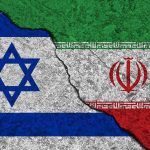 Jihad Chants At Parade Ignite Israel War Fears Israeli and Iranian flags divided by a cracked line.