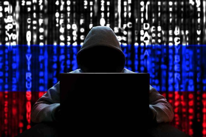 1654709008 Hacker in hoodie with Russian flag background and code.