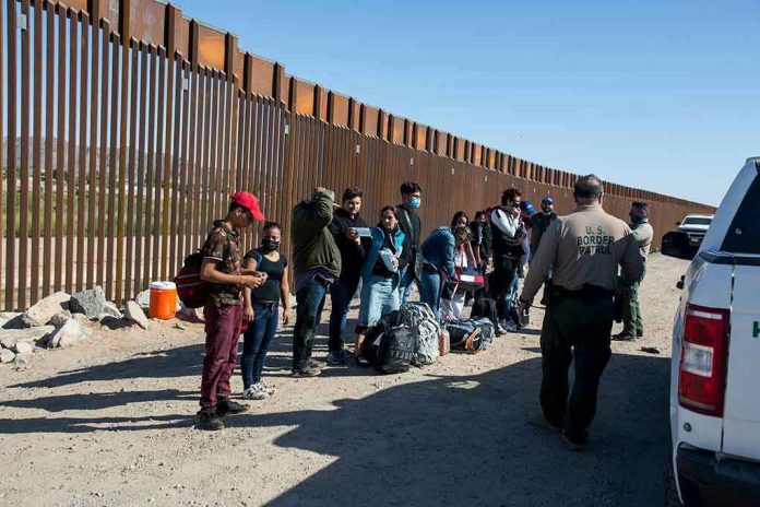 Border patrol agents interact with a group of people.