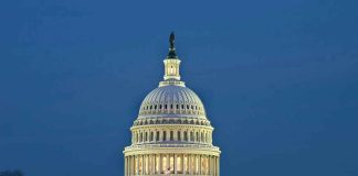 U.S. Capitol building illuminated at dusk.