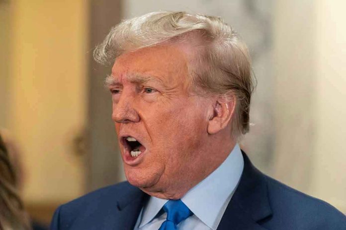 Man in suit with open mouth, speaking passionately.