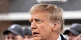 ICE Plans Massive Crackdown on Somali Community Man in suit and red tie speaking outside.