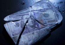 Catastrophic Crash Threatens to Destabilize Global Markets Hundred-dollar bills frozen in cracked ice block.