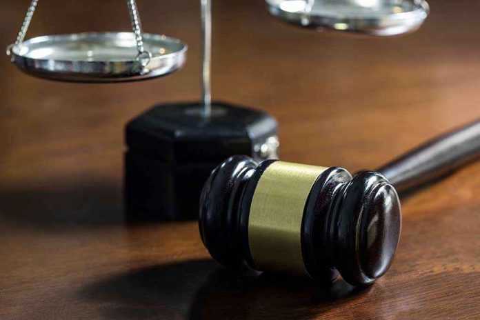 Gavel and scales of justice on wooden table.