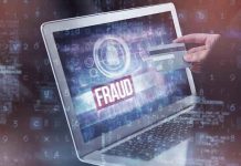 Taxpayer Nightmare: Somali Fraud Scandal Unfolds Person holding credit card near laptop displaying Fraud.