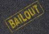 Nonprofit Bail Fund Decision Ends In Murder Yellow BAILOUT text marked on a black asphalt surface