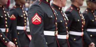 Marines in formal uniforms marching in a parade