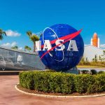 NASA logo sculpture with spaceship and palm trees.