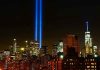 New York City skyline at night with memorial lights.