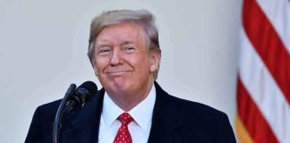 Trump Goes FURTHER Left Than Democrats! Man in suit and tie speaking at podium.