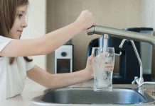 Jet Fuel Spill CHAOS – Tap Water DANGER! Girl filling glass with water from kitchen faucet.