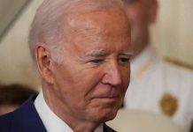 Biden’s Most Catastrophic Failure Man in a suit looking thoughtful.