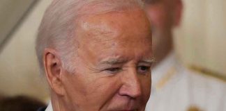 Biden’s Most Catastrophic Failure Man in a suit looking thoughtful.