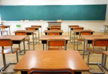 School Leaders Tried To Silence Parents Empty classroom with desks and a chalkboard.