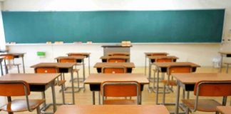 School Leaders Tried To Silence Parents Empty classroom with desks and a chalkboard.