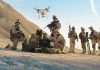Federal Immigration Raid Turns Militarized Soldiers operating a drone in a desert environment.