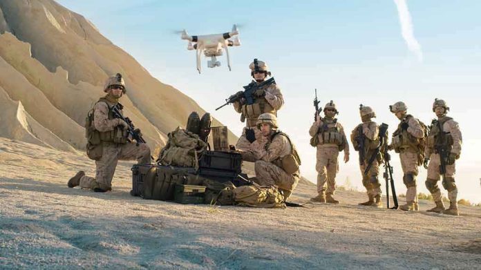 676000819 Soldiers operating a drone in a desert environment.