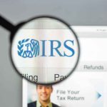 OnlyFans Earnings in Crosshairs Magnifying glass over IRS website.