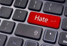 Close-up of a keyboard with a red key labeled Hate