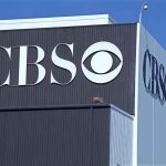 Exterior view of a CBS media building featuring the CBS logo