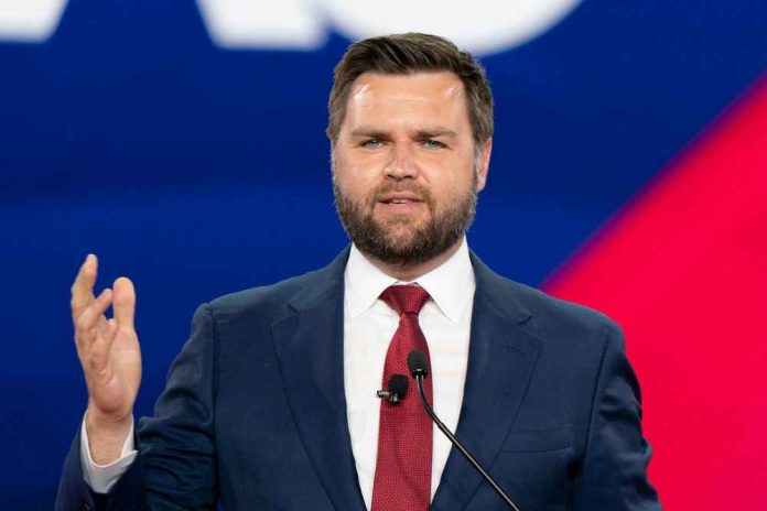 Man in a suit speaking at an event.
