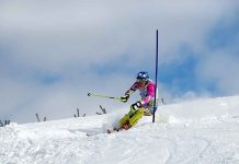 US Skier SLAMMED by Trump Sparks Fury Athlete skiing down a snowy slope around a slalom pole