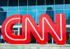 Trump Demands CNN Sale—Chaos Ensues Large red CNN logo in front of a glass building