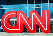 Trump Demands CNN Sale—Chaos Ensues Large red CNN logo in front of a glass building
