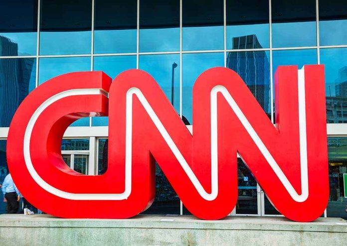 shutterstock_159663854.jpg Large red CNN logo in front of a glass building