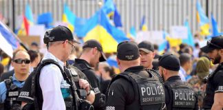 Bill Maher SLAMS Liberal Audience – Unbelievable! Police officers gathered near a crowd with flags.