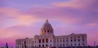 Supreme Court Clash: Alabama’s Bold Map Gamble Historic building with dome under a pinkish-purple sky.