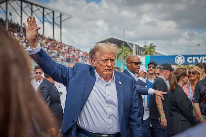 2458373881 Person in blue suit waving at outdoor event.