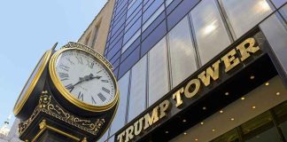 Eric Trump SUES Over China Trip Claims Clock in front of Trump Tower building entrance.