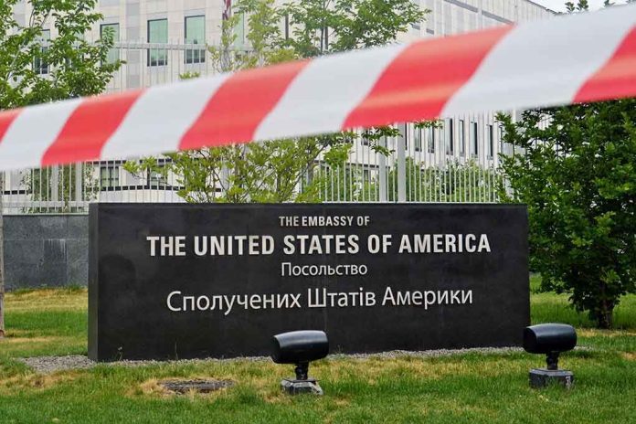 U.S. Embassy sign behind red-and-white caution tape.