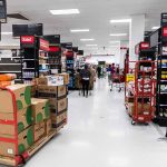AI Cameras: Retail Savior or Overhyped Gadget? Interior of a grocery store with shelves filled with products and shoppers